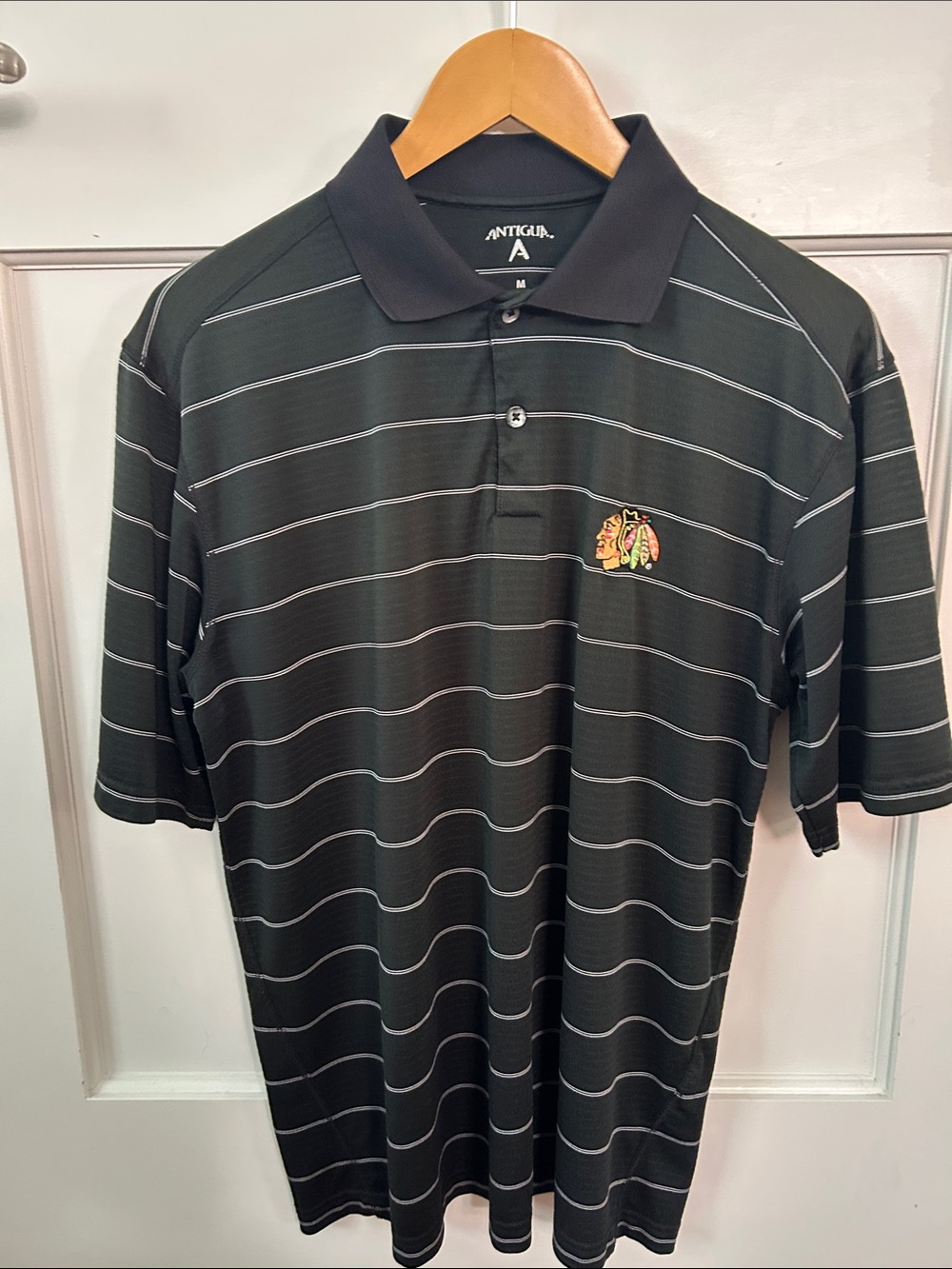 Antigua Black Polo with White Stripe and Chicago Blackhawks Crest